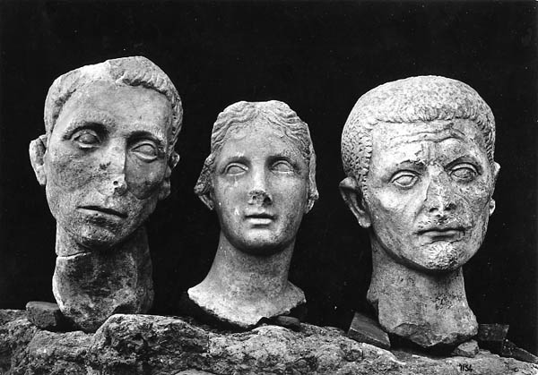 "Muse and portraits of citizens" excavation photo of the heads of three Roman sculptures from Minturnae, Italy, 1931-1933. Penn Museum image #182924